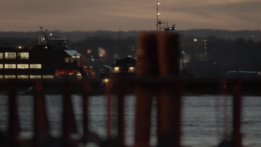 Ferryboat travels across the sea at dusk