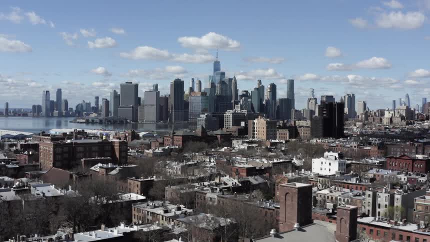 The skyline of a major metropolis under a blue sky