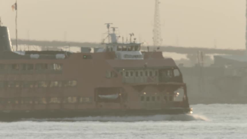 Large ship travels on the river under a cloudy sky