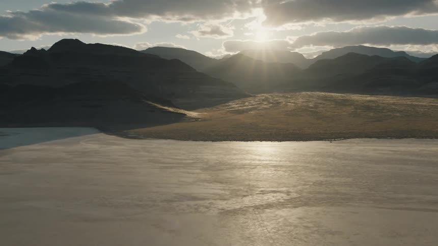 A desert landscape with mountains and the sky in the background