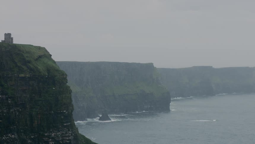 A tower sits atop a cliff near the ocean