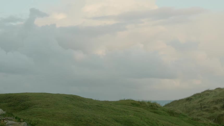 Hills covered in low grass on a cloudy day