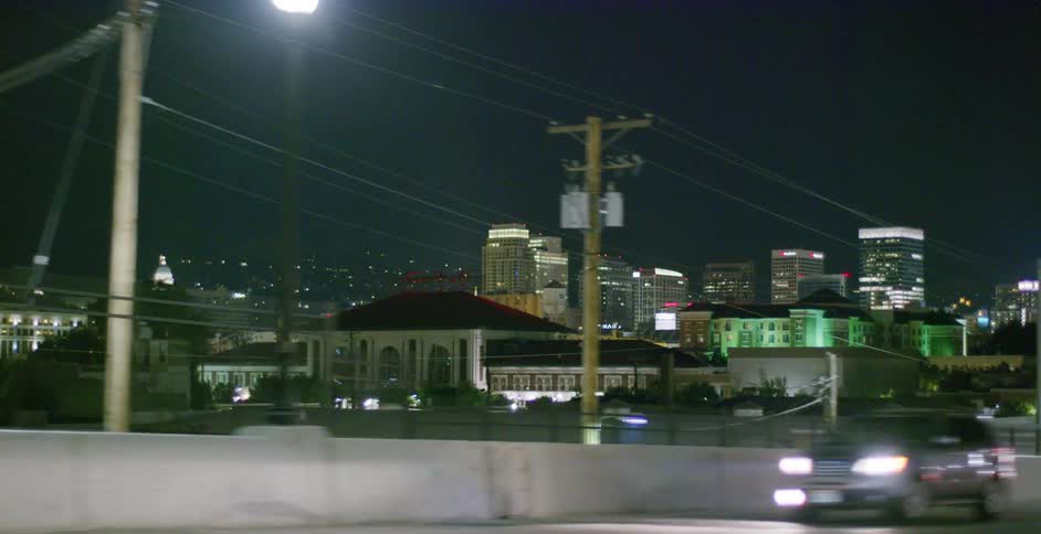 Cars are driving on a highway near a downtown city