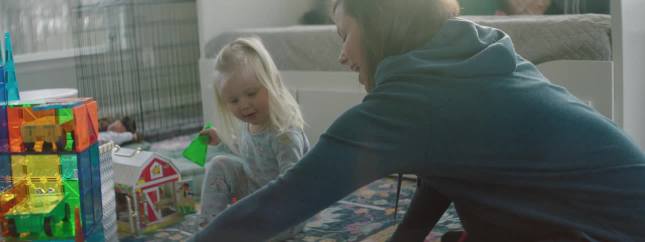 A mother and child are playing indoors
