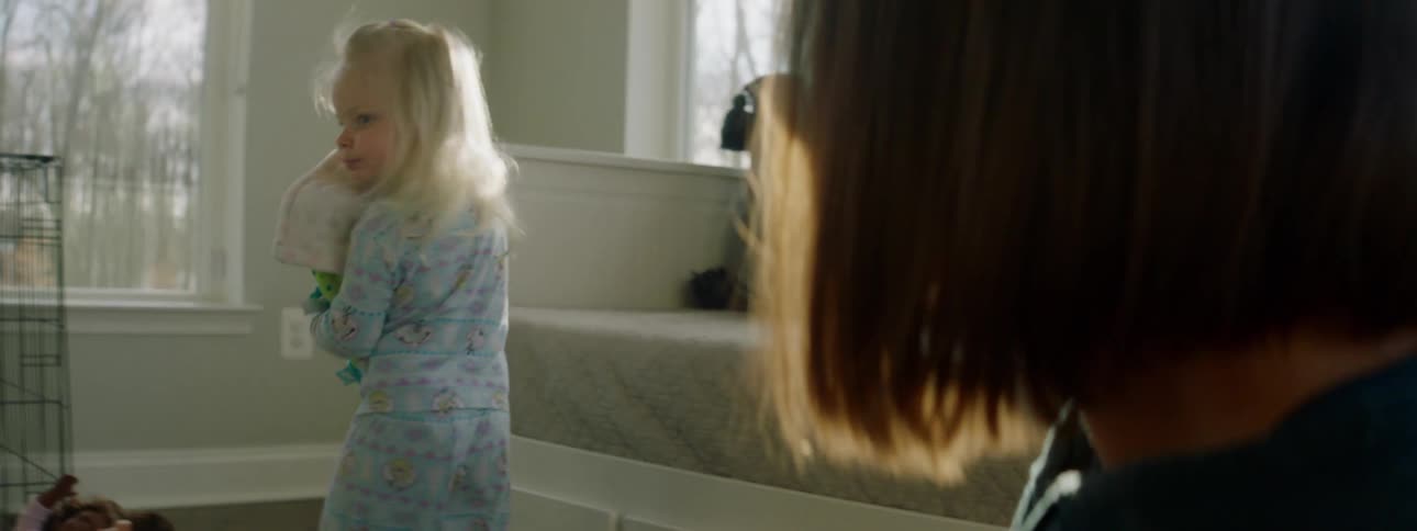A mother and daughter are indoors playing