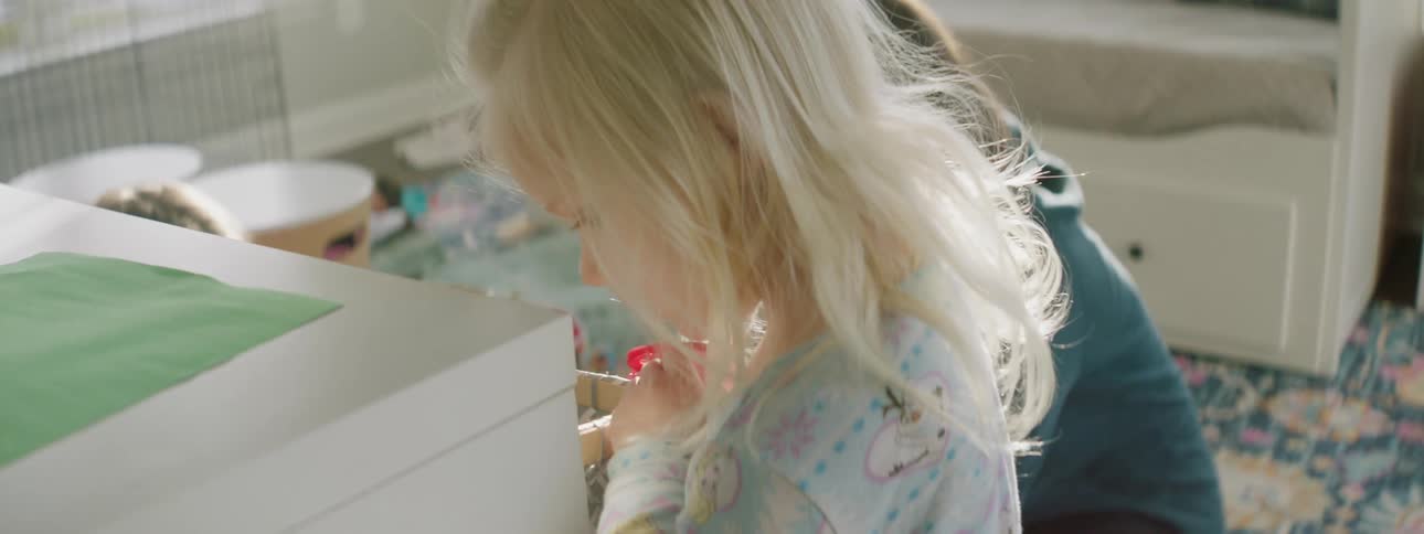 Mother and daughter play together in the living room at home