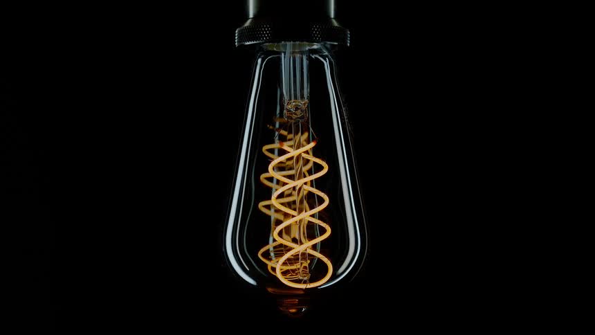 A light bulb flickers on and off