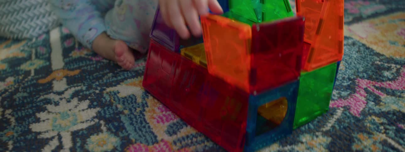 A baby is playing with toys indoors