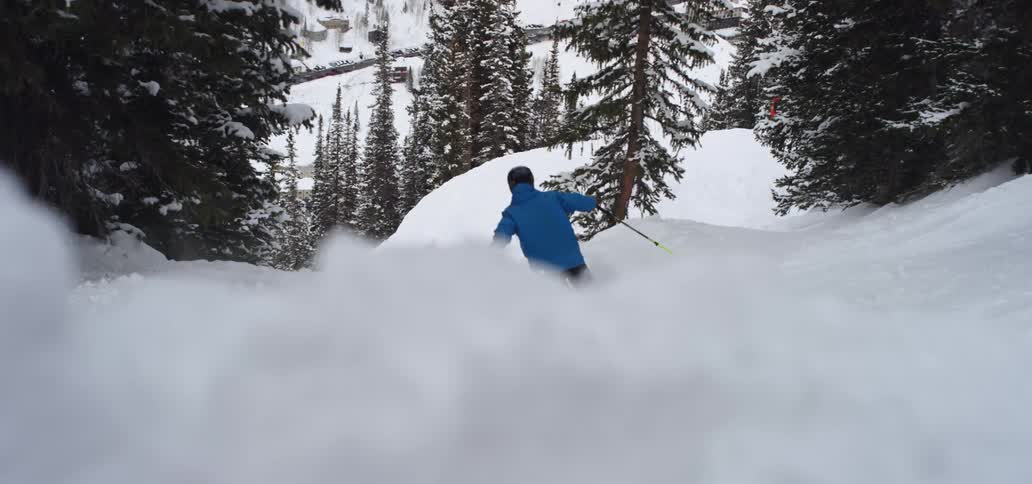A person skis on snowy hills