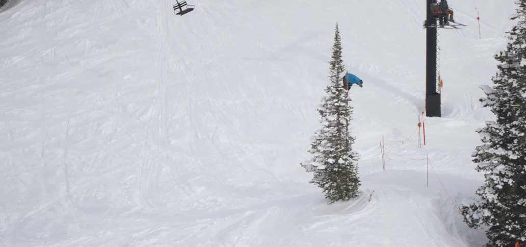 The person jumps while skiing