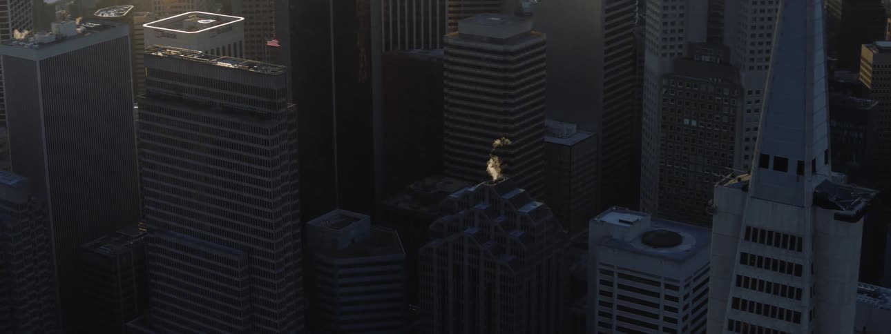Sun shines on waterfront and downtown city from near horizon