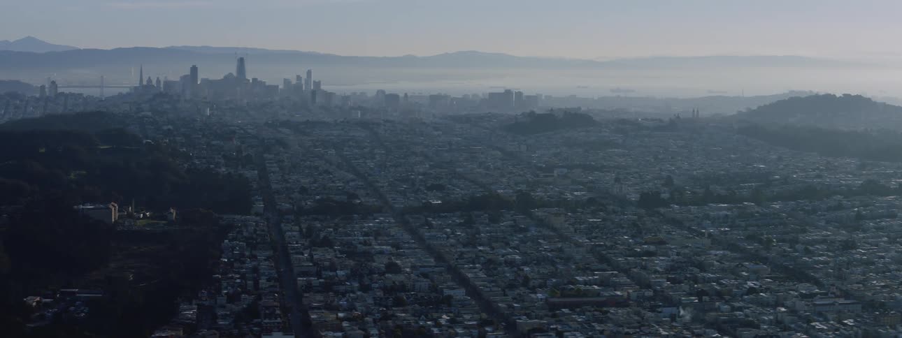 City sits at dusk near the mountains