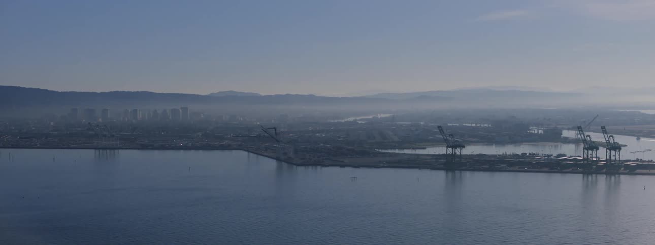The water and pier with a city skyline in the far off distance