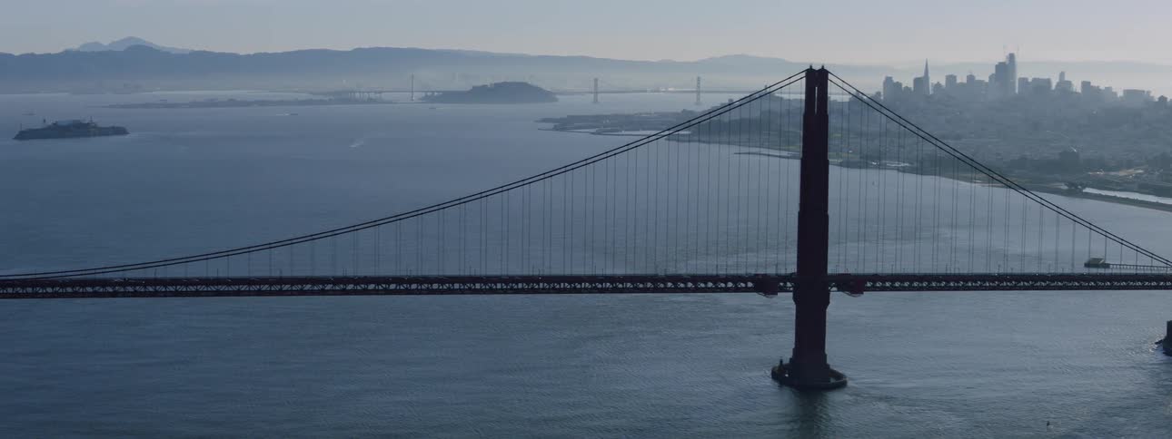 Traffic is nonexistent on the golden gate bridge at dusk