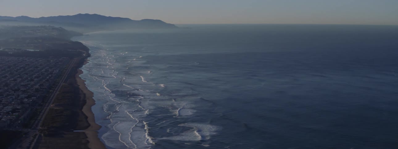 Ocean waves crash into a shoreline
