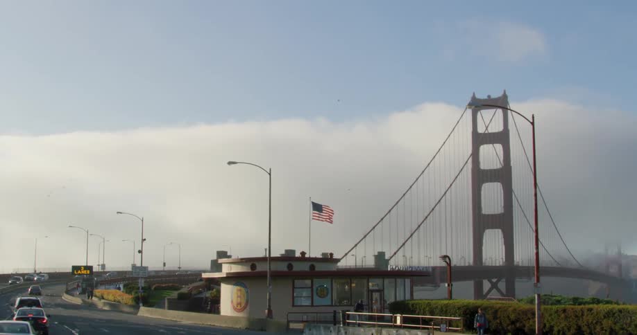 Cars travel across the golden gate bridge on a cloudy day
