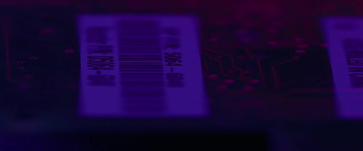 An electronic circuit board with tags and blue light flashing and shining