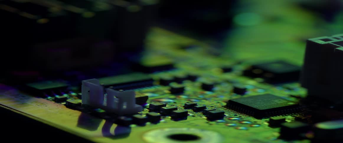 A motherboard illuminated with coloured lights