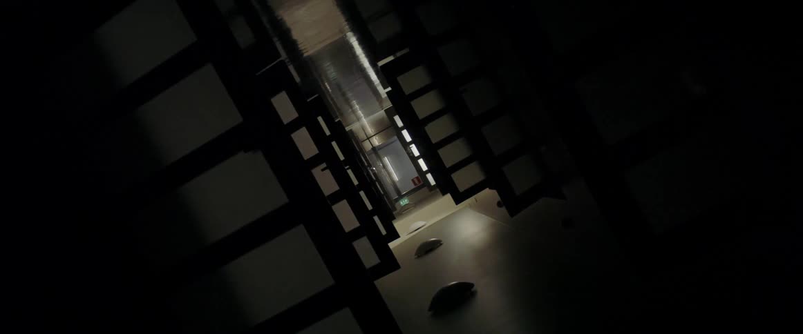 A hallway with room dividers and flashing lights
