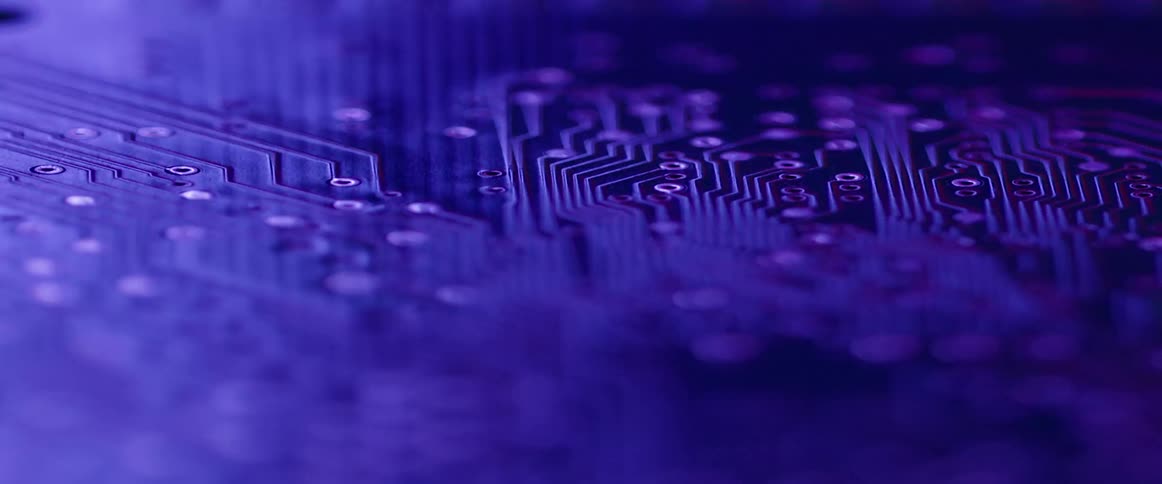 Light and colors blend together over a circuit board