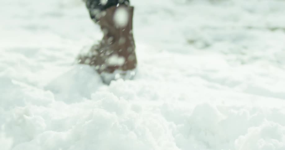Someone wearing heavy boots running in snow