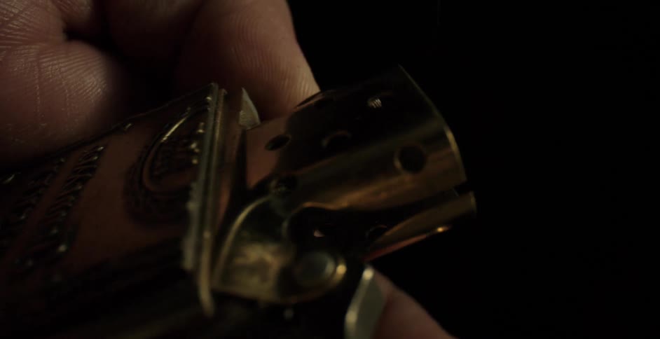 Close up of hand attempting to ignite vintage flip top lighter