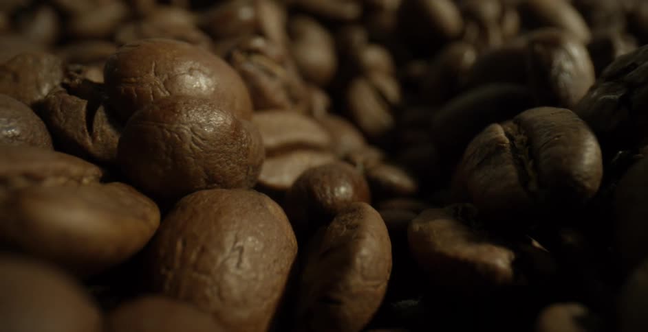 A pile of brown coffee beans in a pile