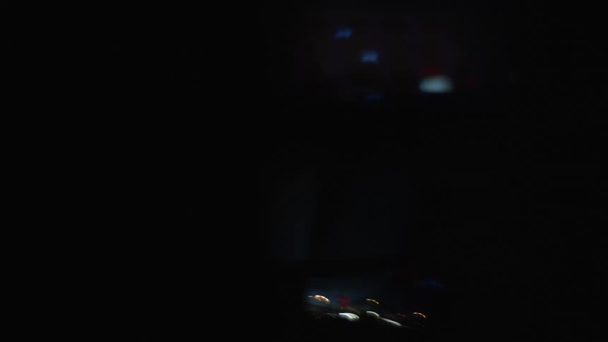 Red and blue lights reflect off the side mirror of an emergency response vehicle