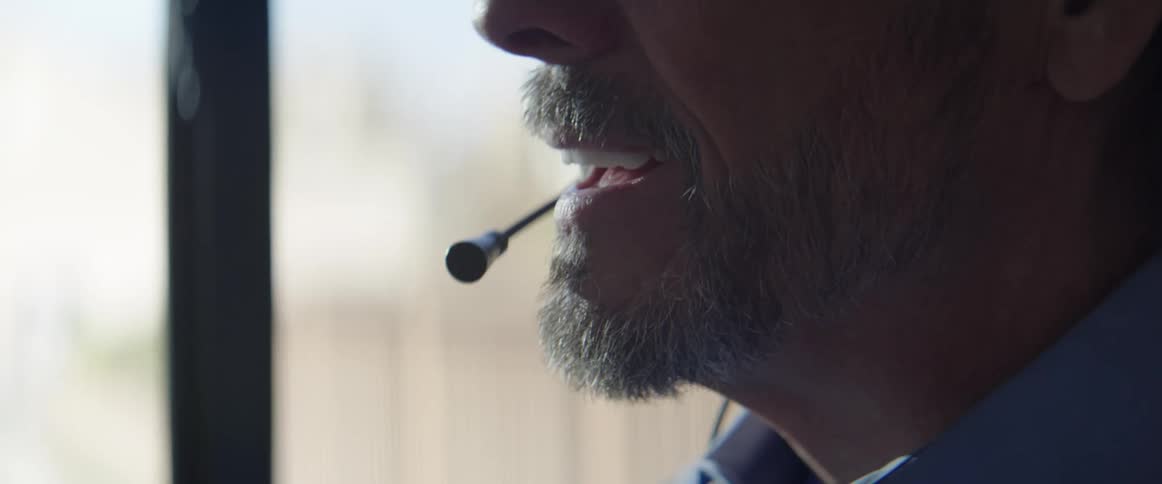 Man wearing headphones starts making a phone call