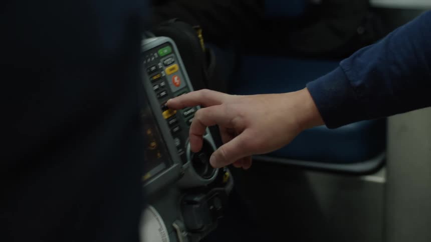 A man uses electronic equipment on a bus