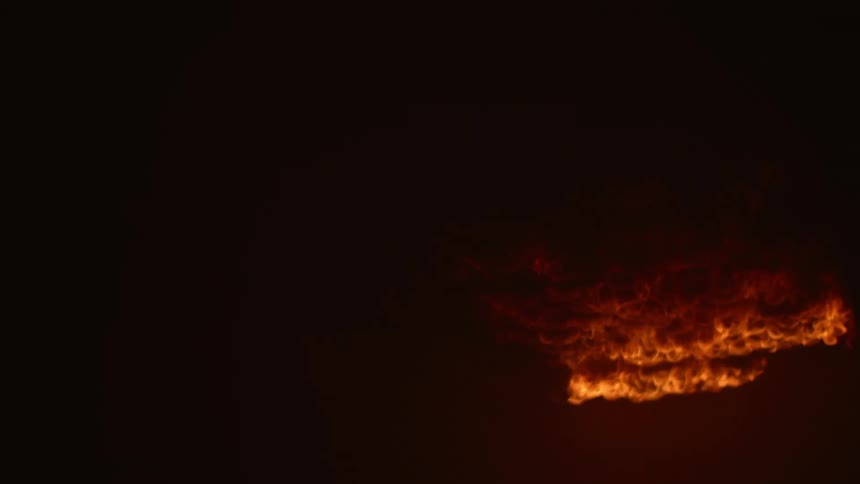 A fire burns at night