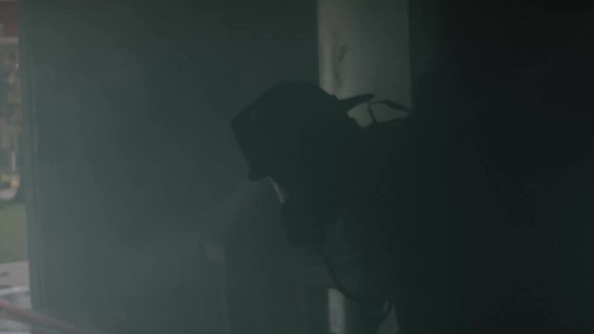 A firefighter is in a building with equipment