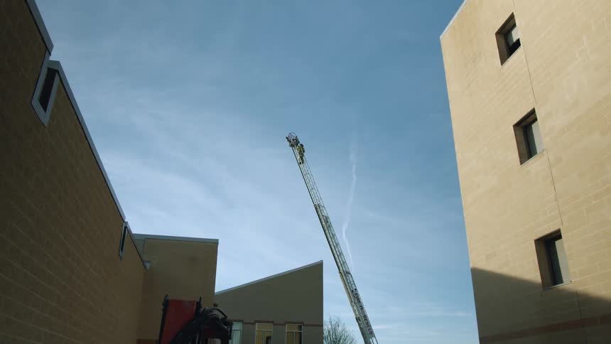The crane ladder sits between the buildings