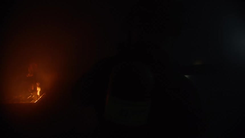 A firefighter moves towards a fire