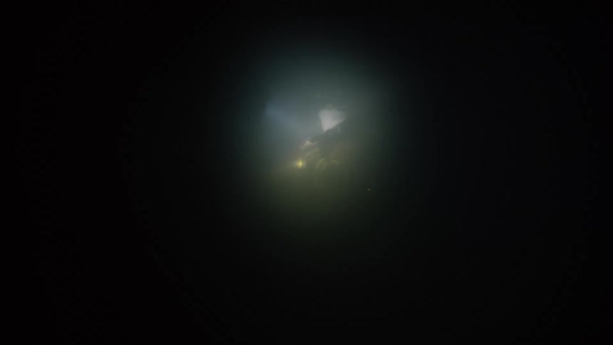 Two firefighters move in the dark