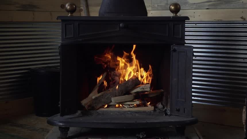 View of a burning fireplace with crackling fire
