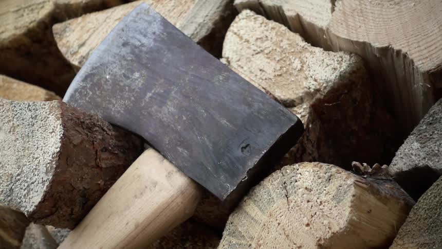 An axe lies on chopped wood