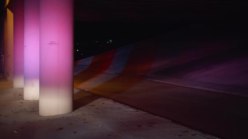 Sirens flash and reflect off of a concrete pillar