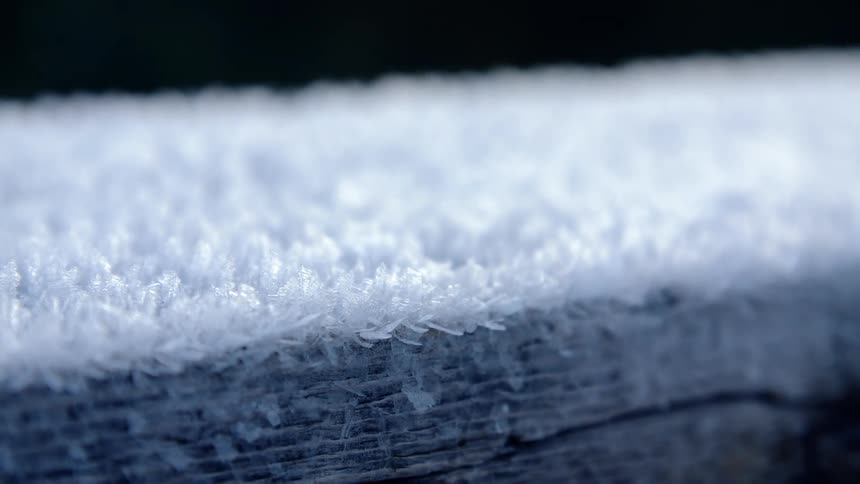 Several layers of carpet lie on a floor