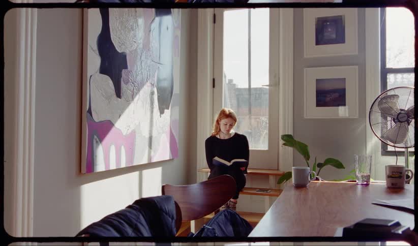 Red haired woman reads a book