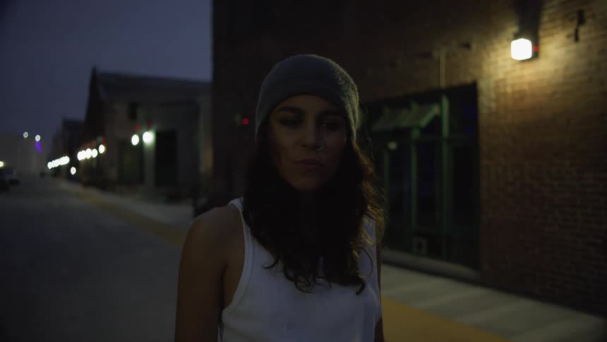 A woman is standing outside the building