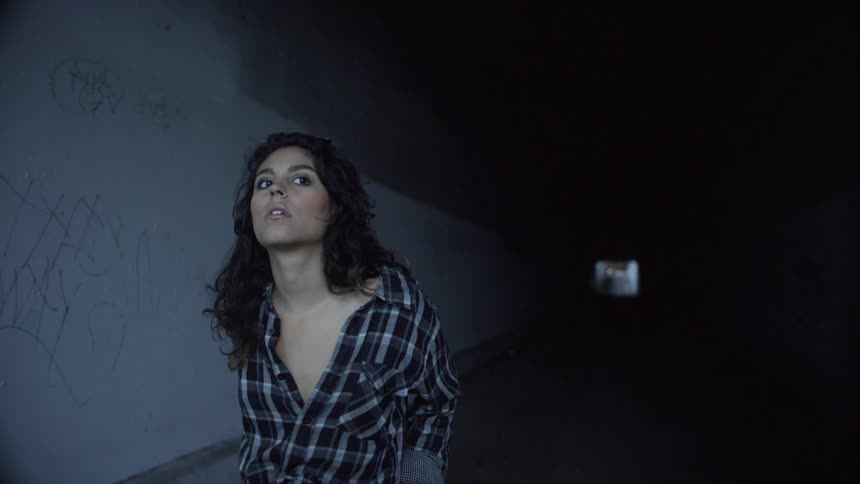 A woman is walking through the tunnel