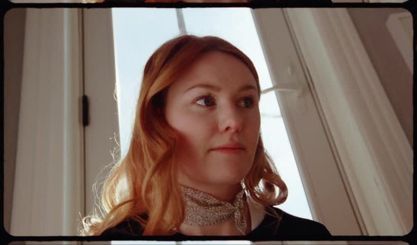 Redhead woman sitting on the floor inside a room