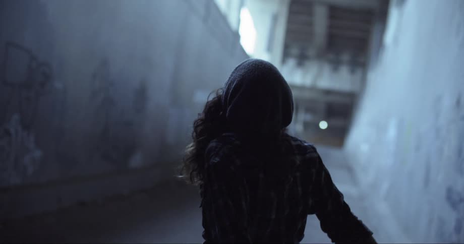 A person dancing in an alleyway