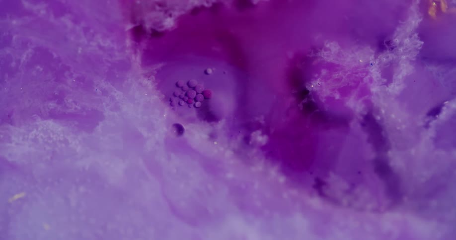 Delicate looking purple crystals and flakes shift and move