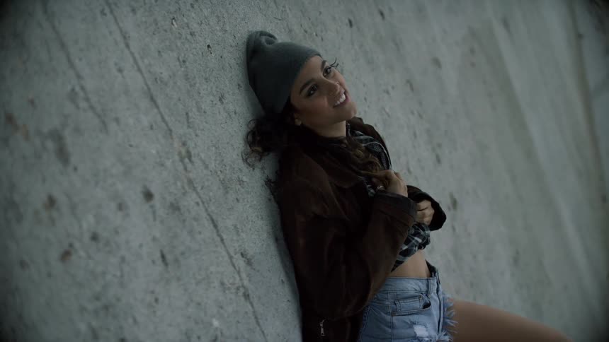 A woman is laying on the concrete