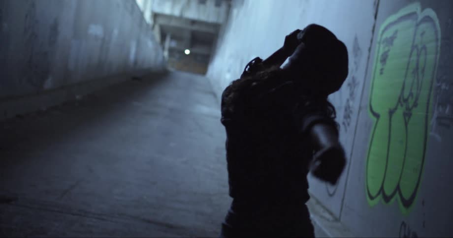 Silhouette of a woman dances in a building