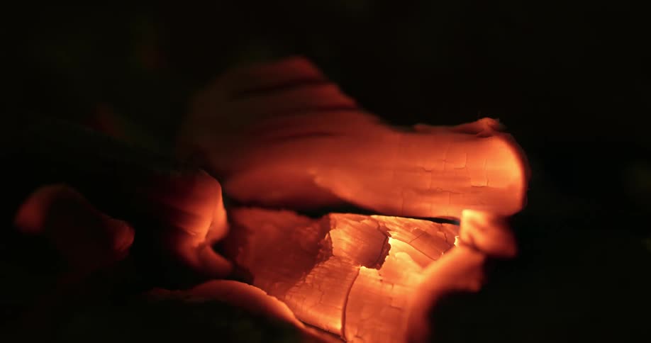 The ember glows from hot coal made of heated wood