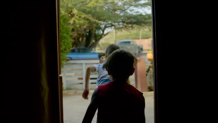 Two boys run outside to play