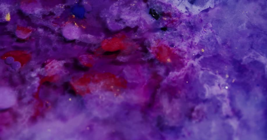 Brightly colored crimson and purple masses move slowly